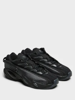 Nocta Glide Sneakers i Black, Black, Iron Grey og University Gold